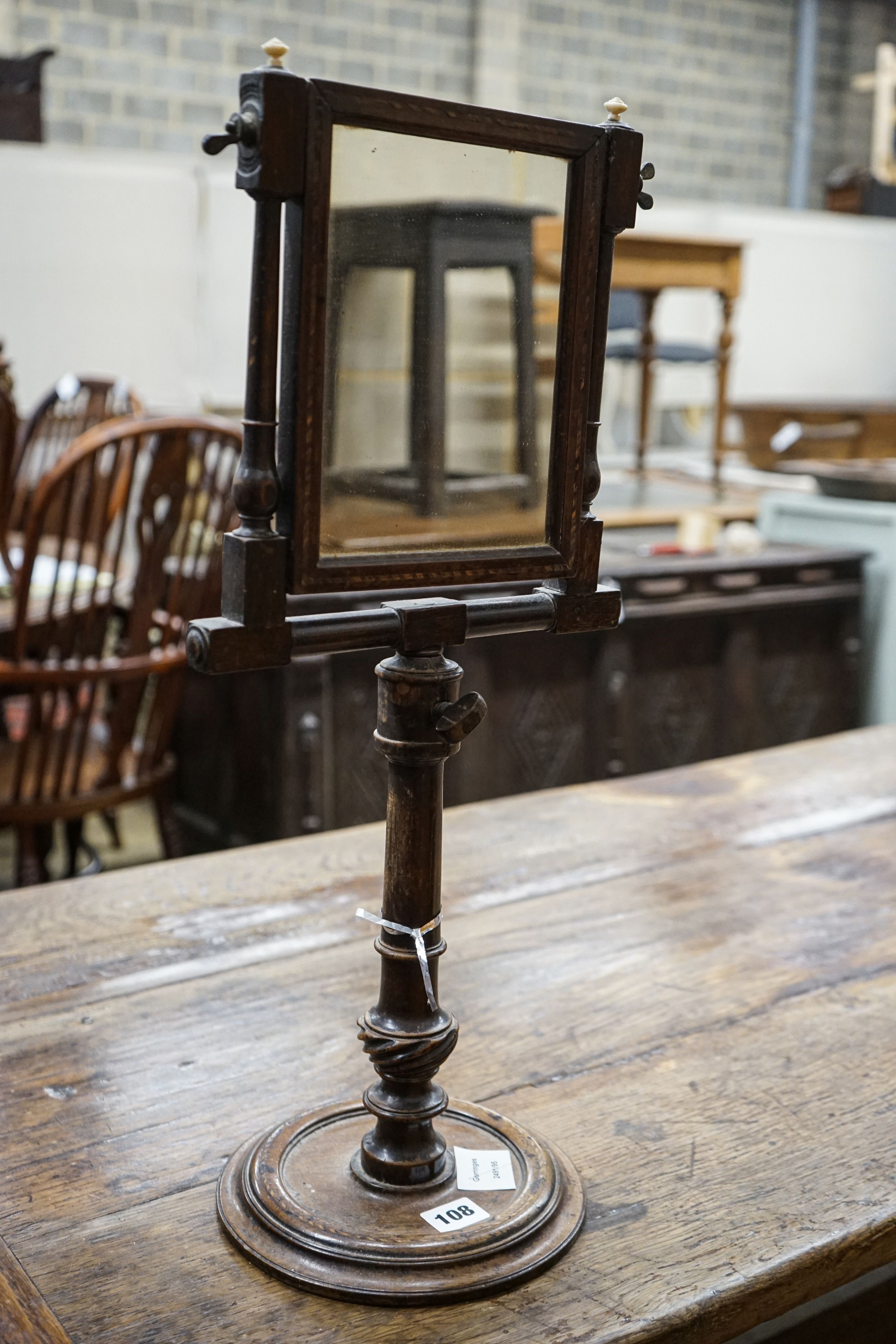 An antique stained beech and walnut telescopic shaving mirror, with barber's pole stringing, height 59cm